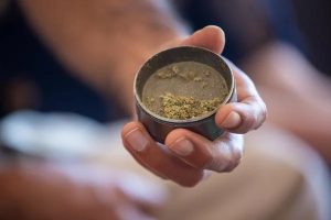 Man Hand Holding Small Silver Tray with weed