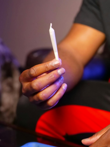 A man holding a joint